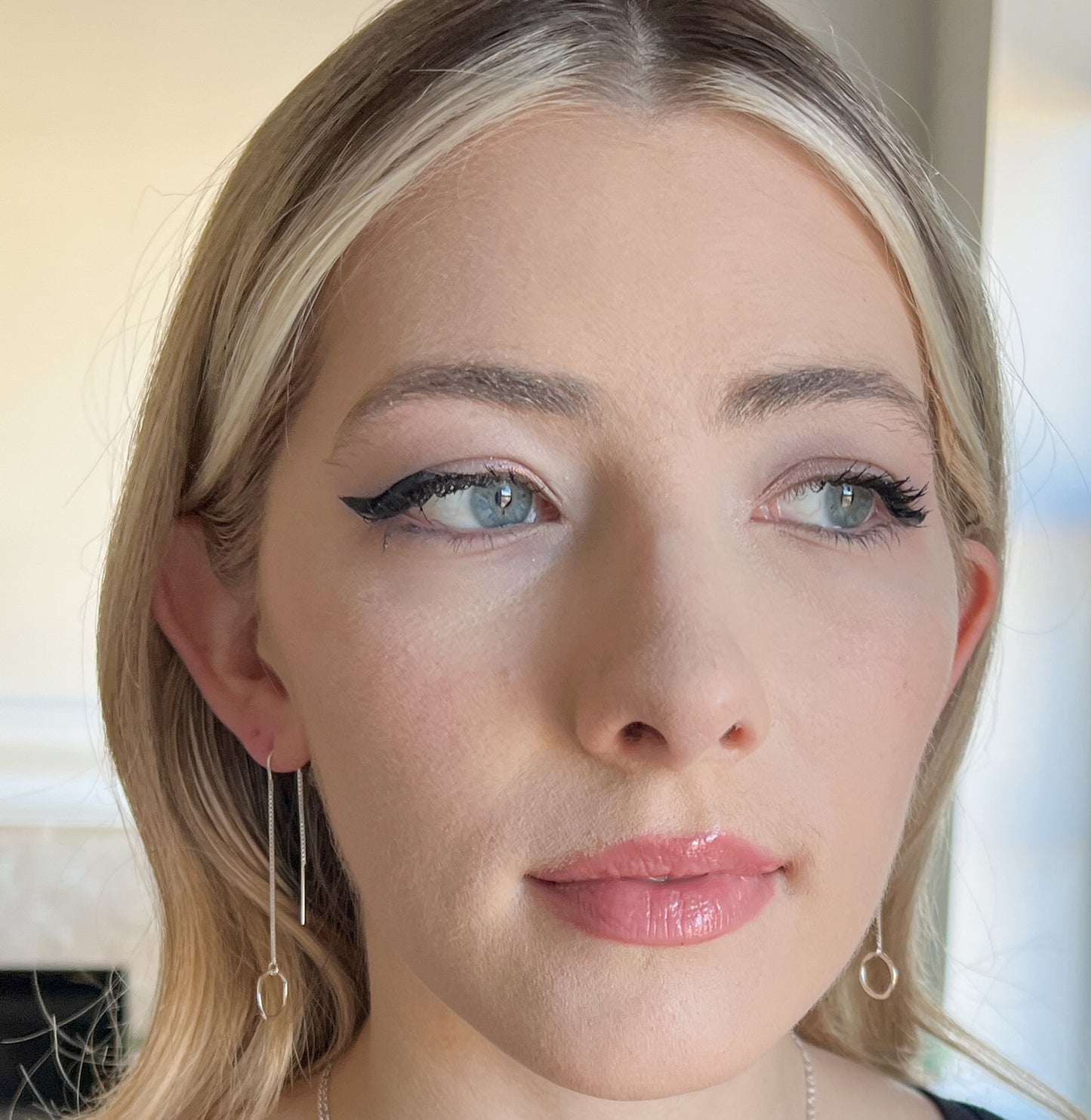 Hypoallergenic threader earrings. Model is wearing 925 sterling silver threader earrings with hammered circle. 2 inch long in front