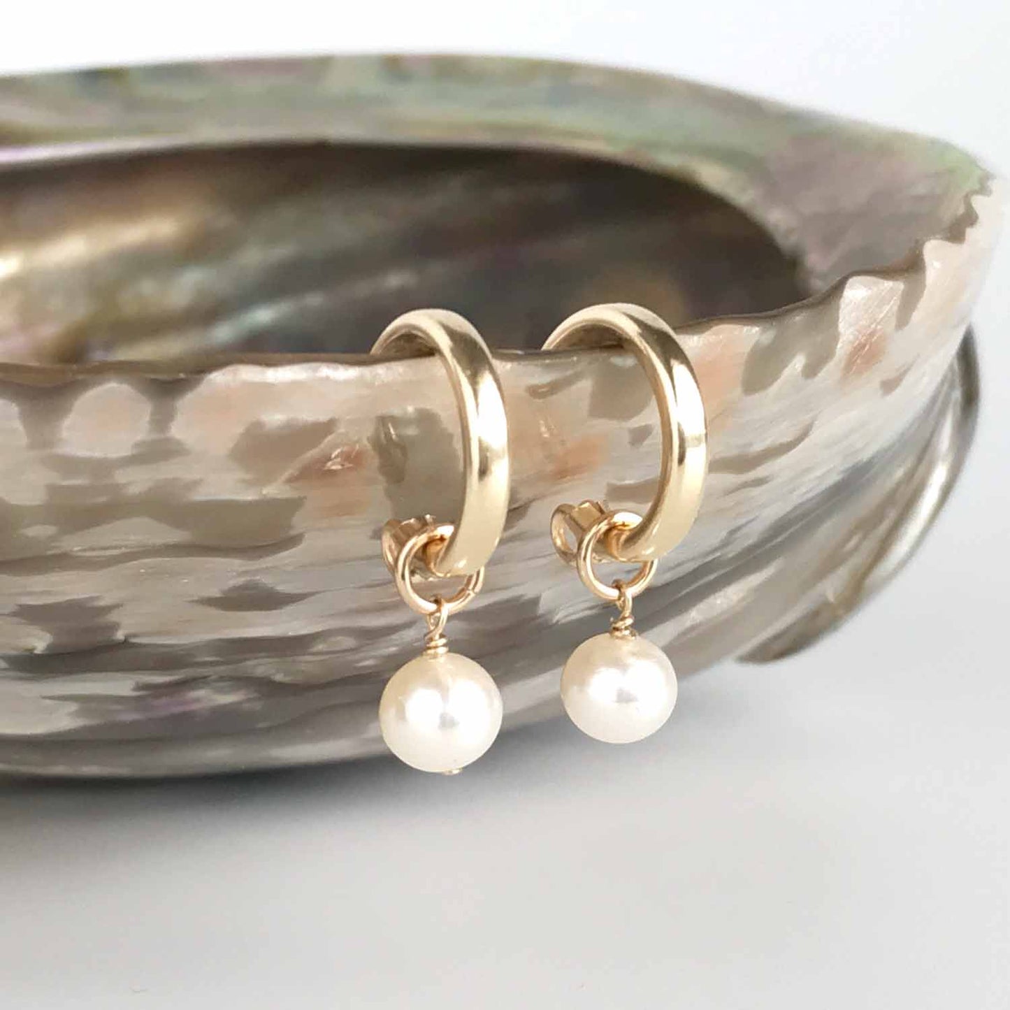 pair of hoop earrings with pearl dangles