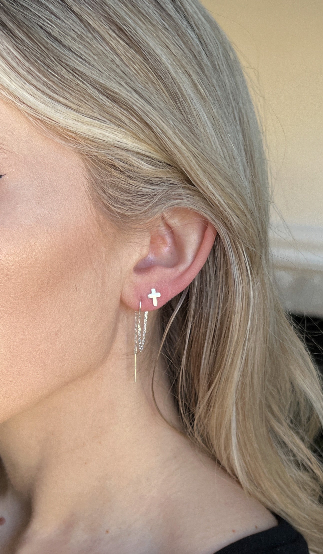 double piercing earrings for women model showing cross stud earring in upper piercing and threader earring in the lower piercing
