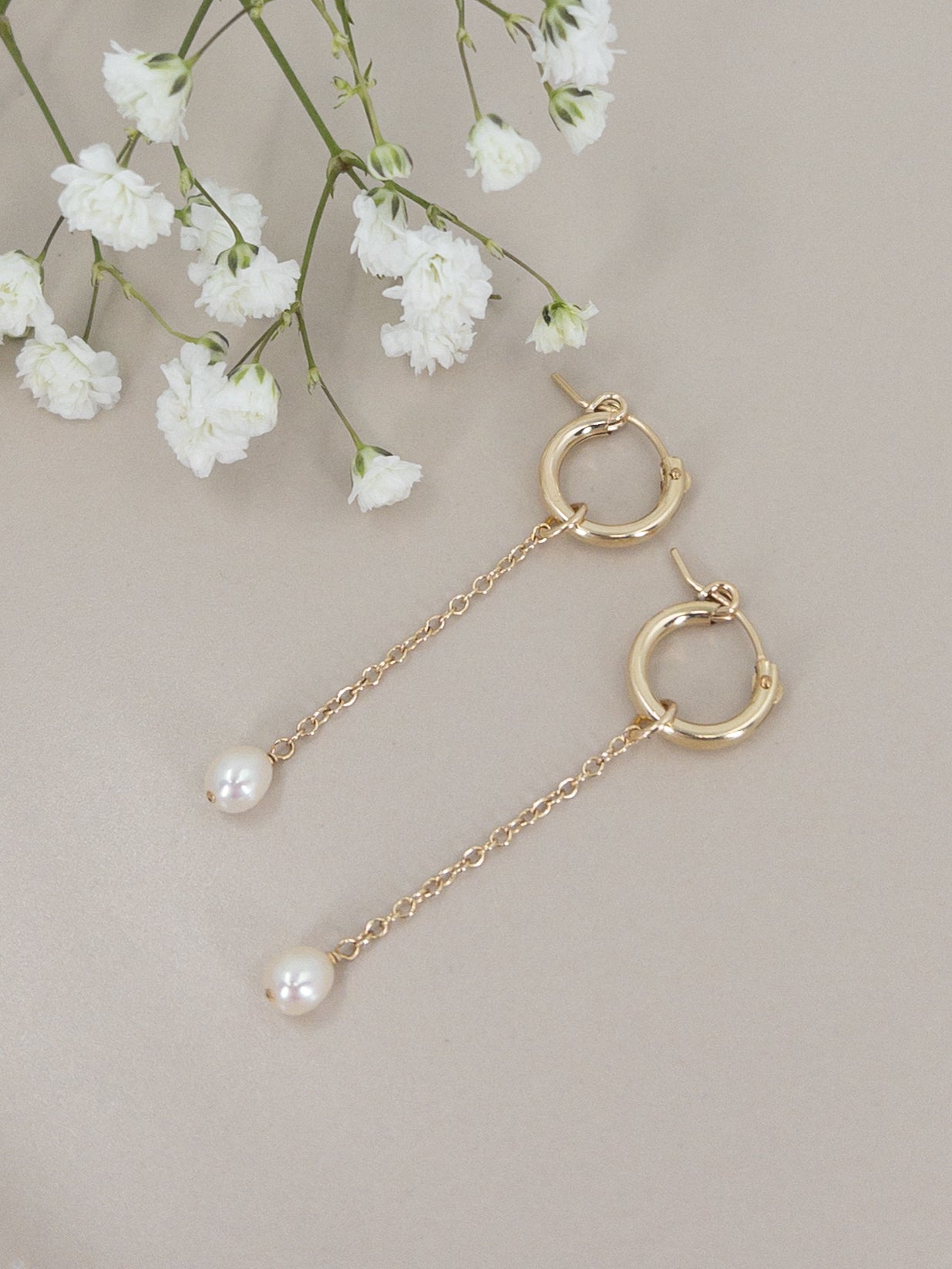 pair of 14k gold filled huggie hoop earrings with pearl dangles