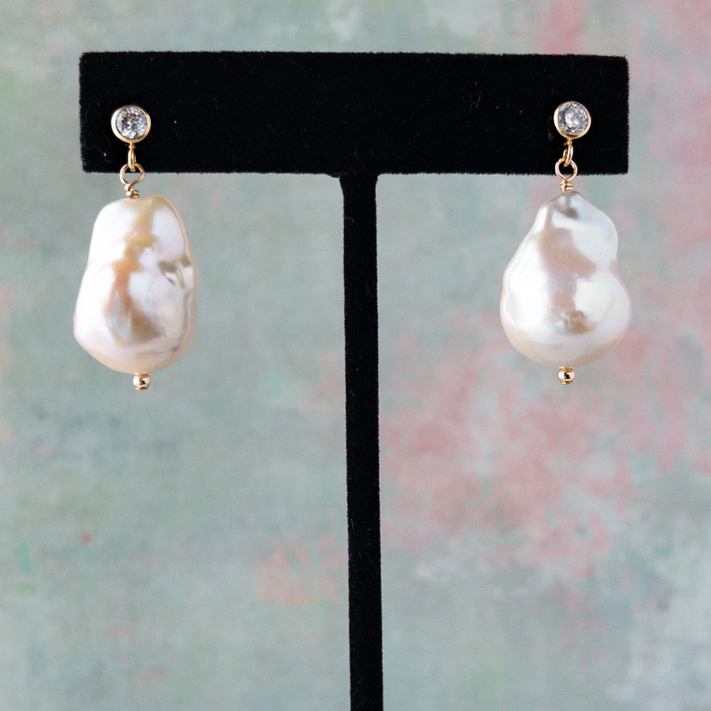 baroque pearl stud earrings on earring stand