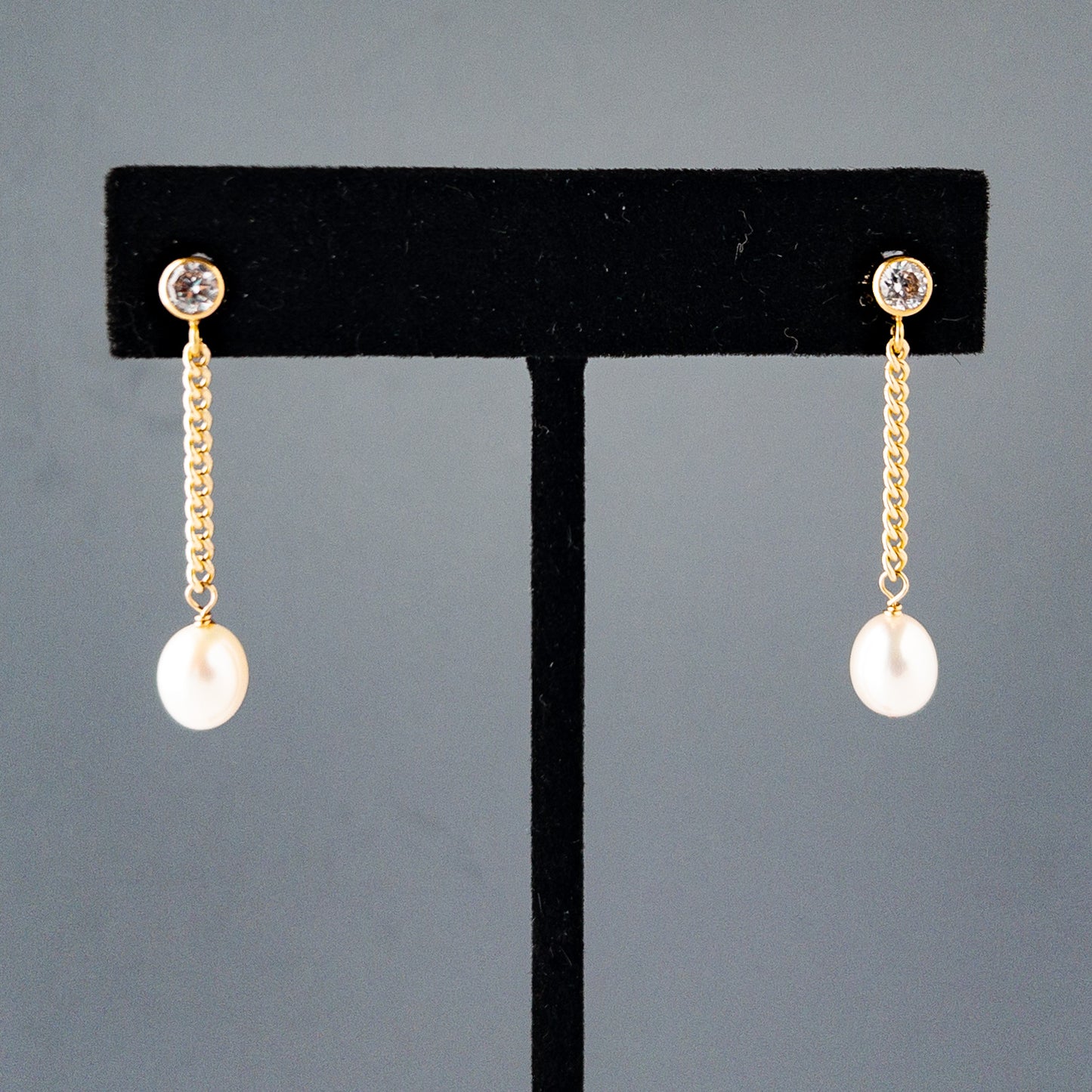 Nicola Pearl Drop Earrings shown on earring stand