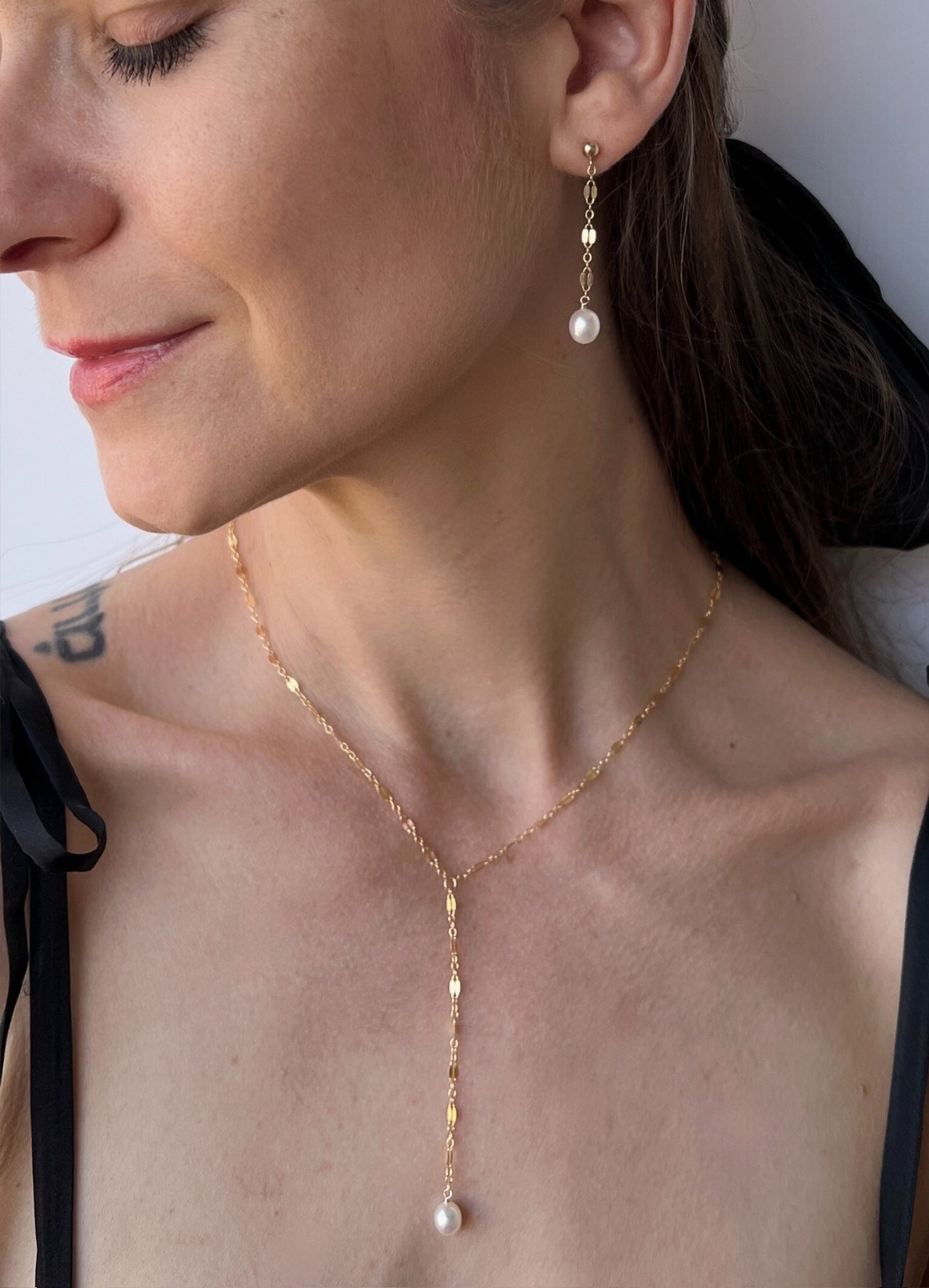 close up of Isabella necklace and earrings on model