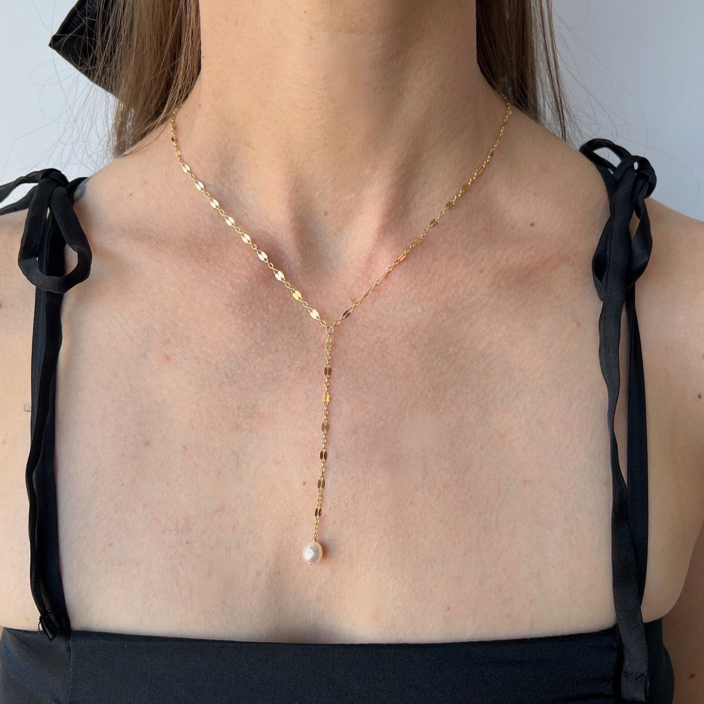 model wearing Isabella lace chain pearl Y necklace in gold
