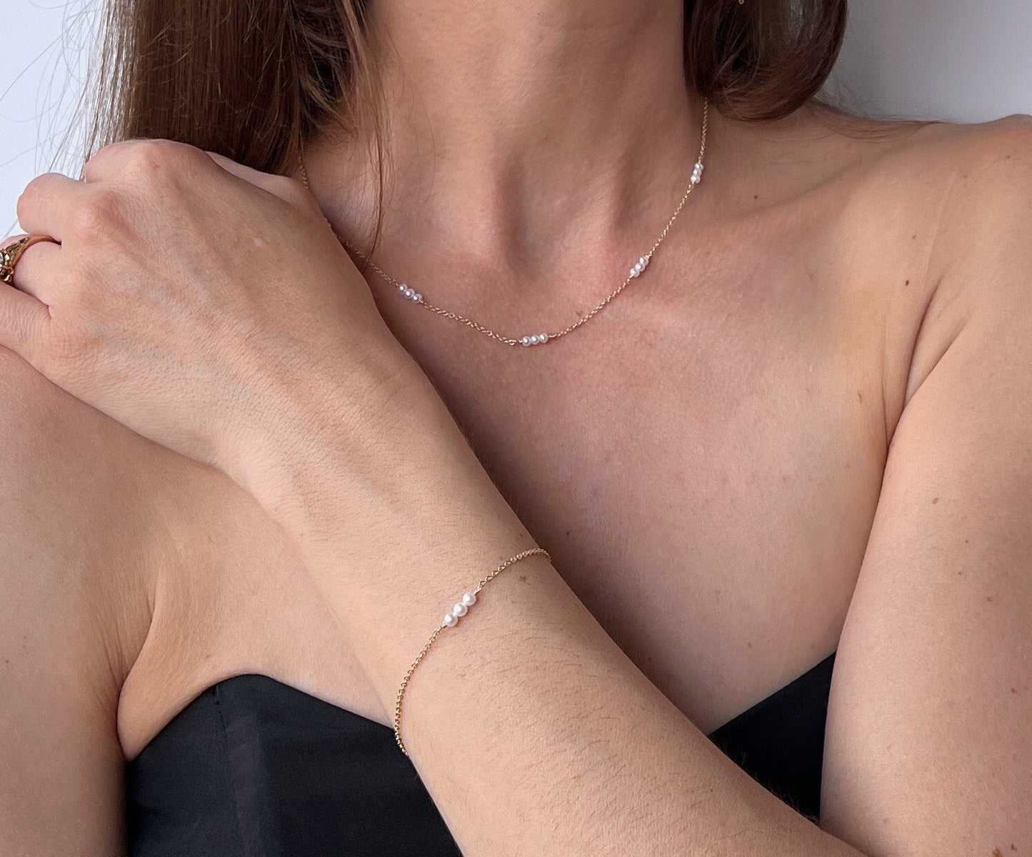 Model wearing small pearl bracelet on 14k gold filled chain. Available in sterling silver or 14k Gold filled. It's the perfect pearl bracelet for wedding.