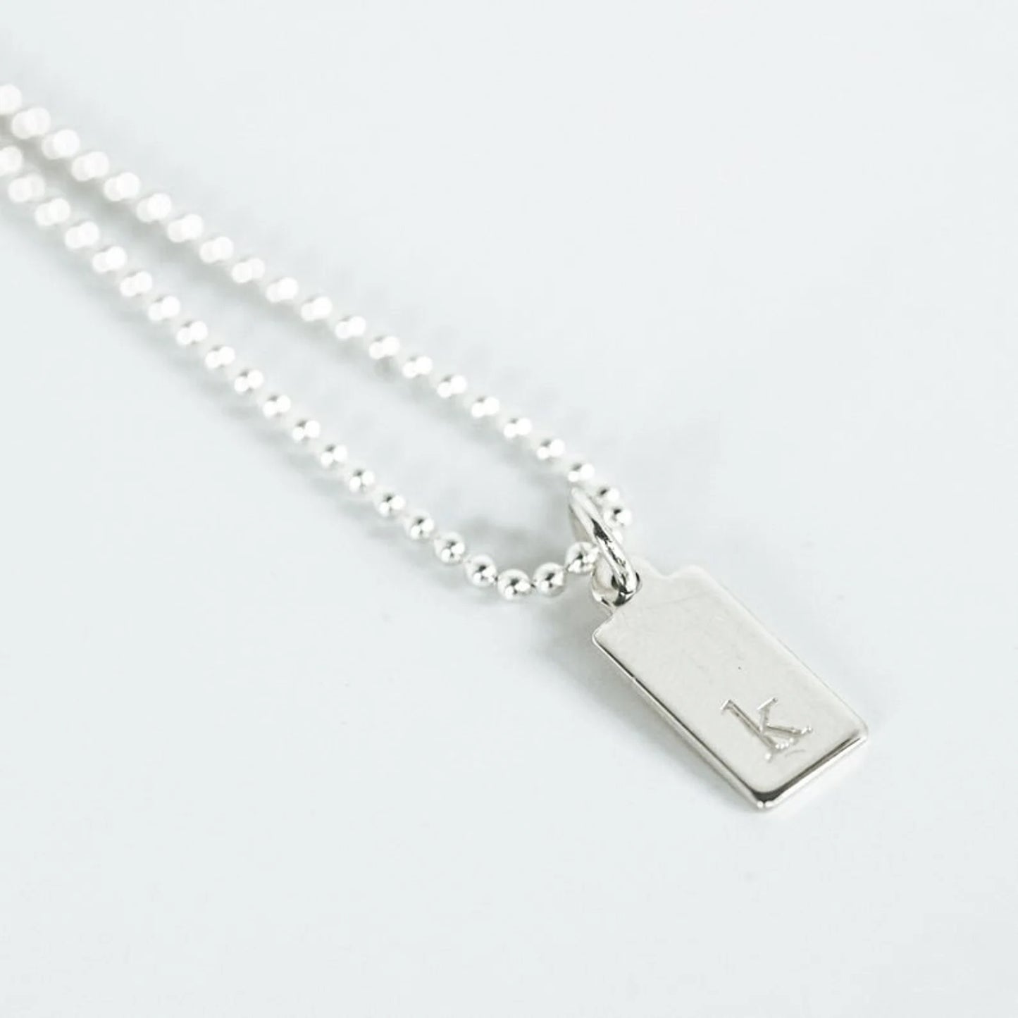 sterling silver beaded chain with small engraved tag with single initial