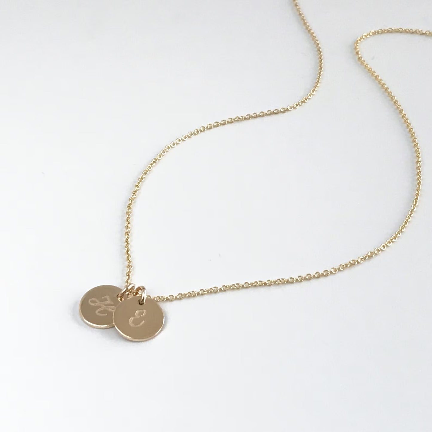 14k gold filled necklace with small initial charms engraved with single letter