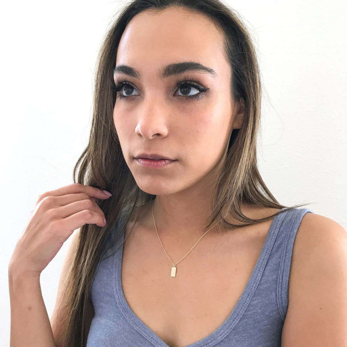 model wearing dainty tag necklace