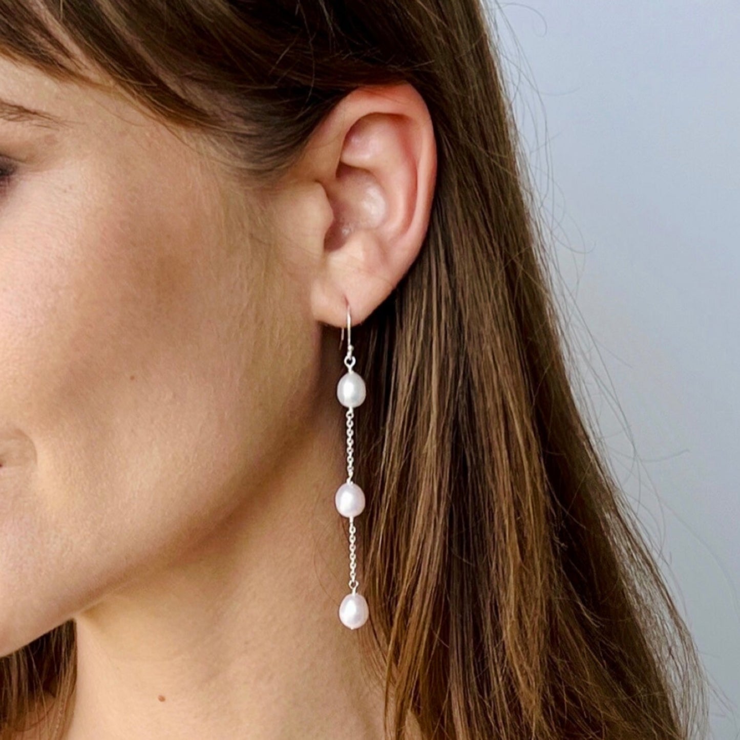 model wearing Nicola Long Pearl earrings in sterling silver with french wire