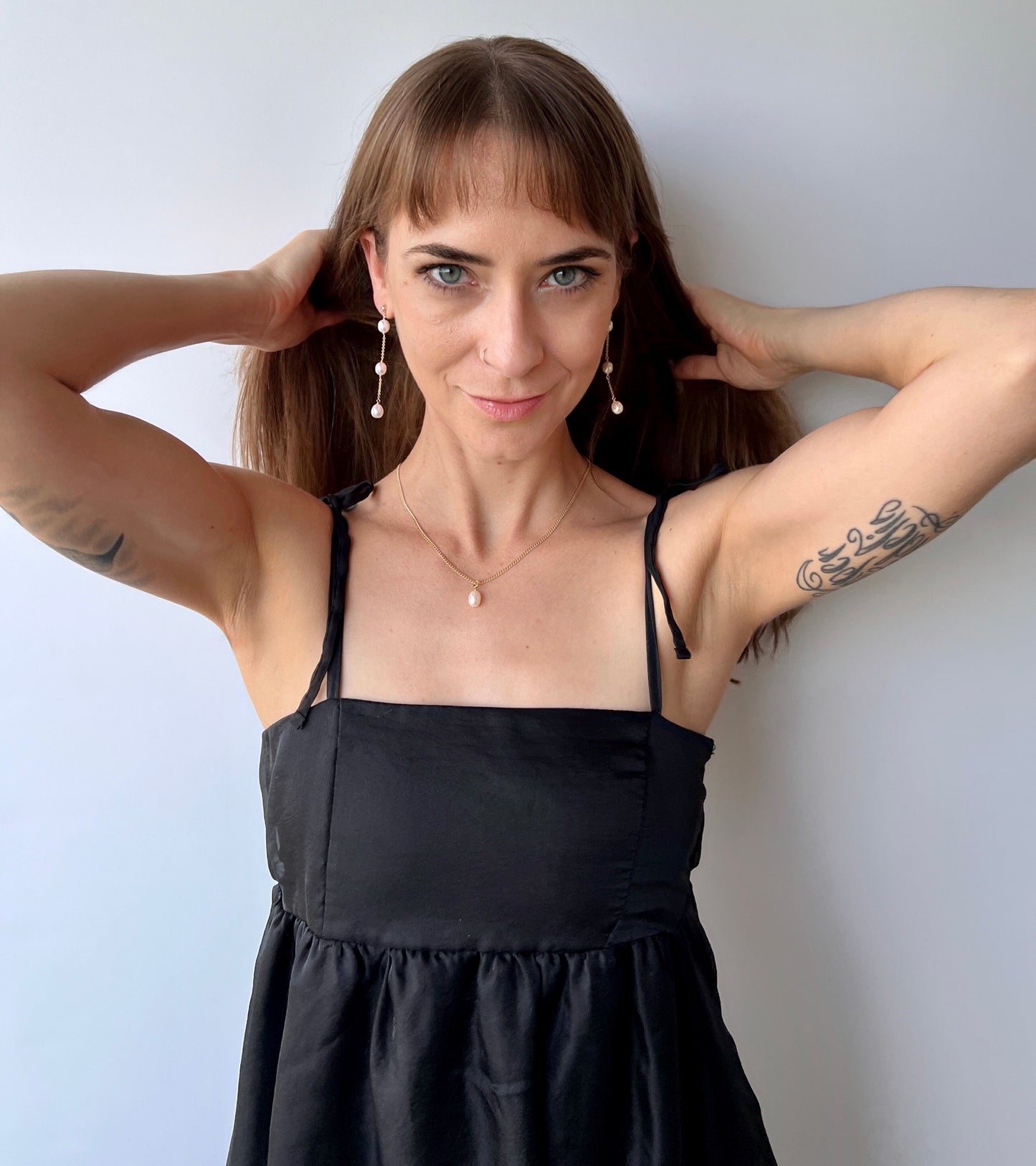 model wearing long dangle pearl earrings