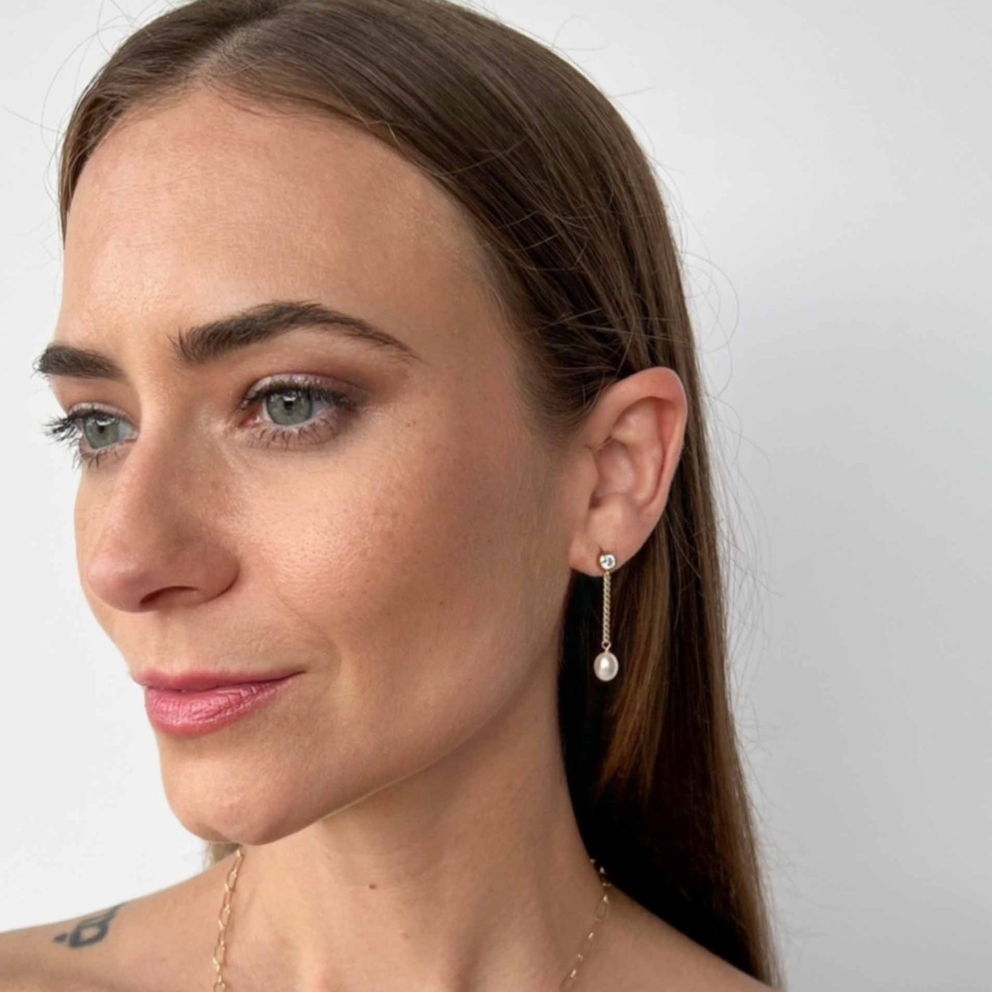 model wearing Nicola pearl dangle earrings