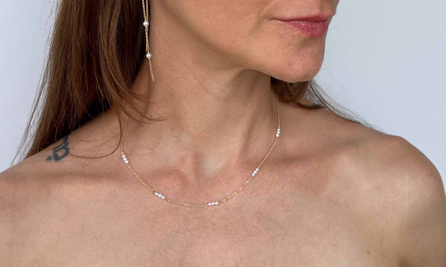 Model wearing gold chain pearl necklace in 16 inch length