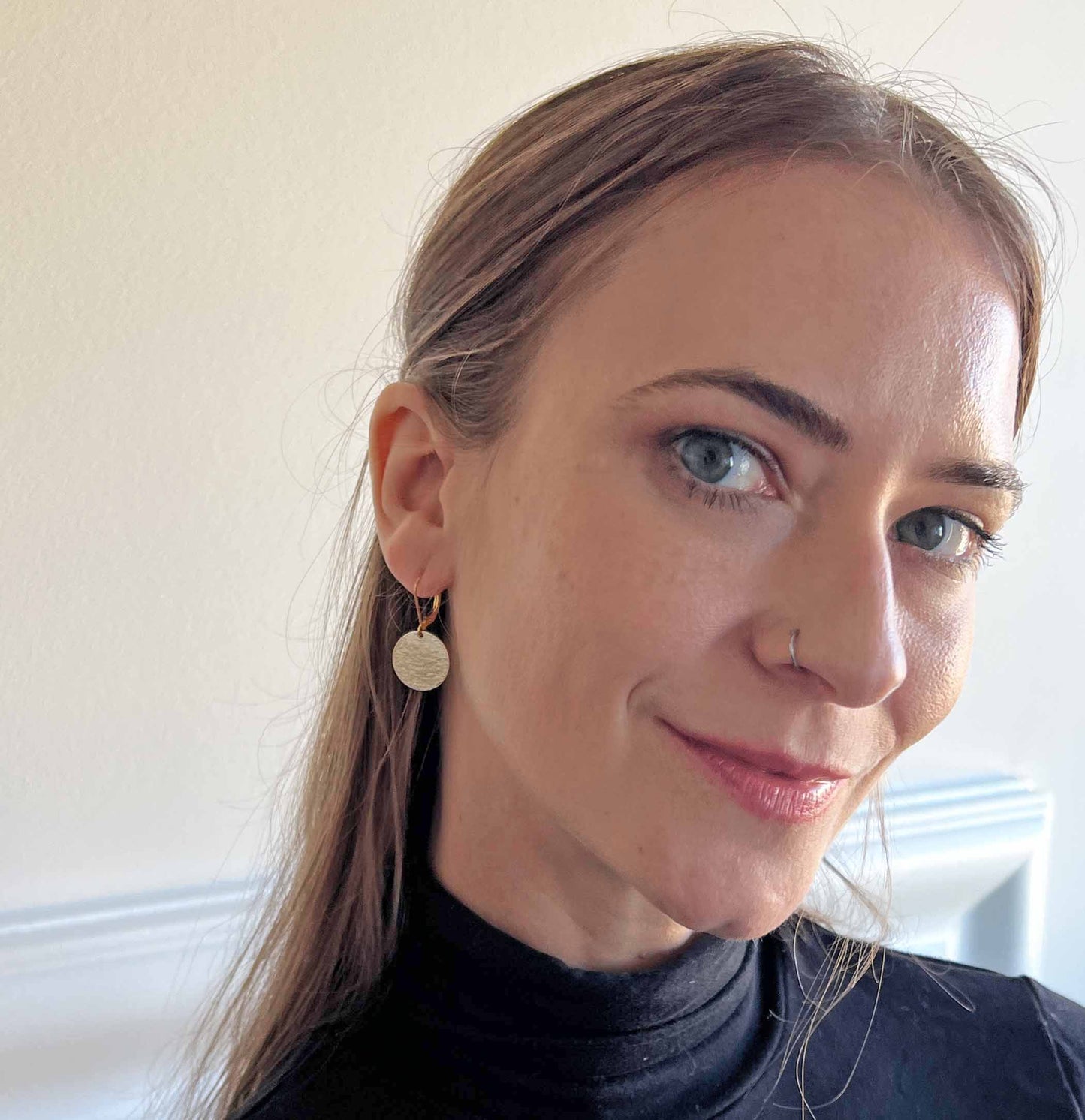 model wearing hammered disc earrings