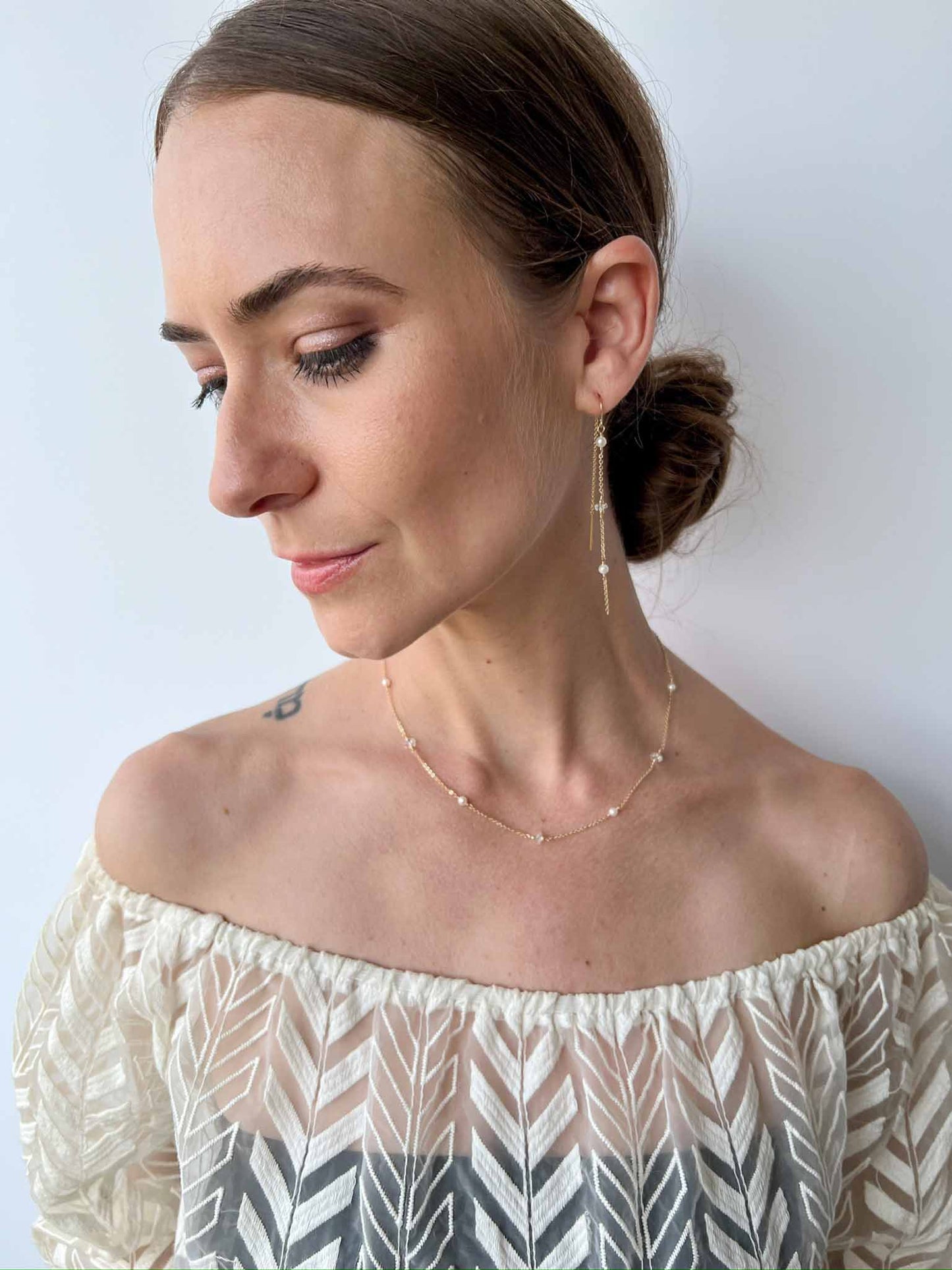 model wearing matching earrings and necklace with pearls and herkimer diamonds