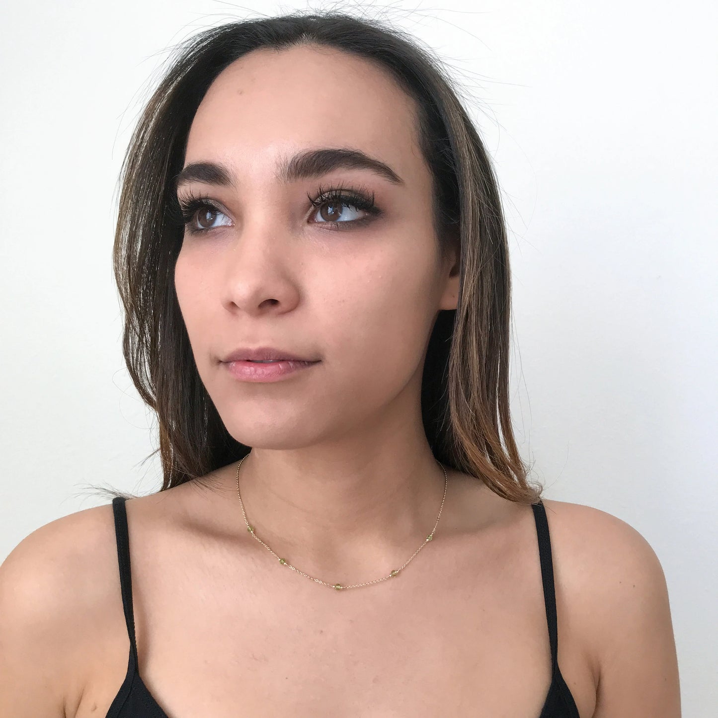 model wearing 16 inch peridot station necklace