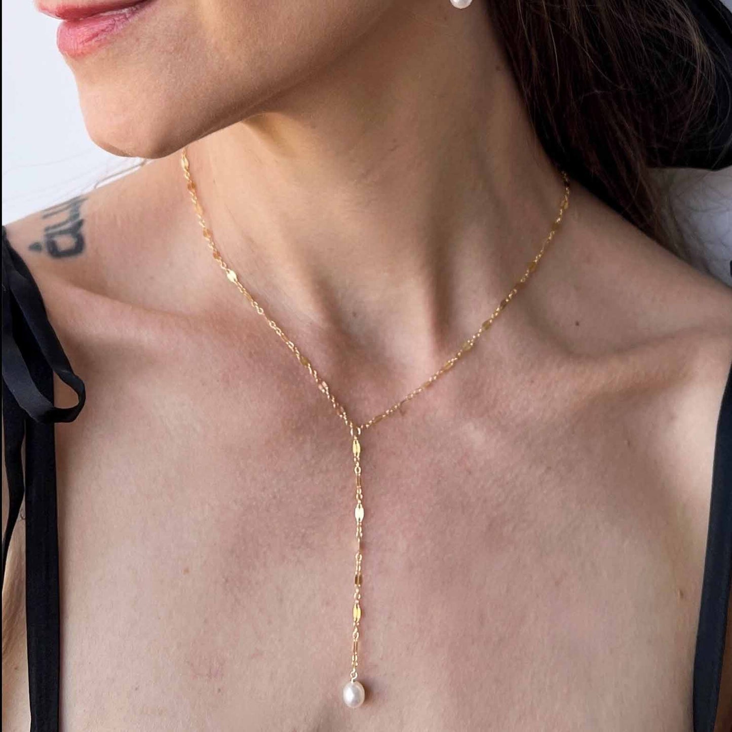 model wearing pearl lariat necklace in 14k gold filled