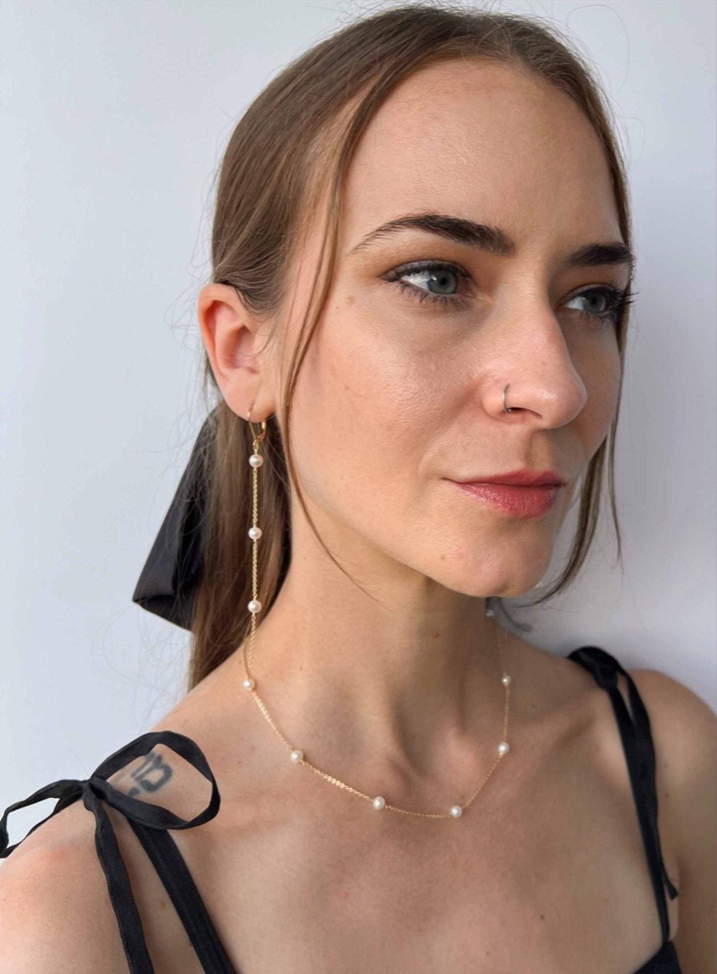 model wearing matching set of necklace and earrings from Lucia Collection