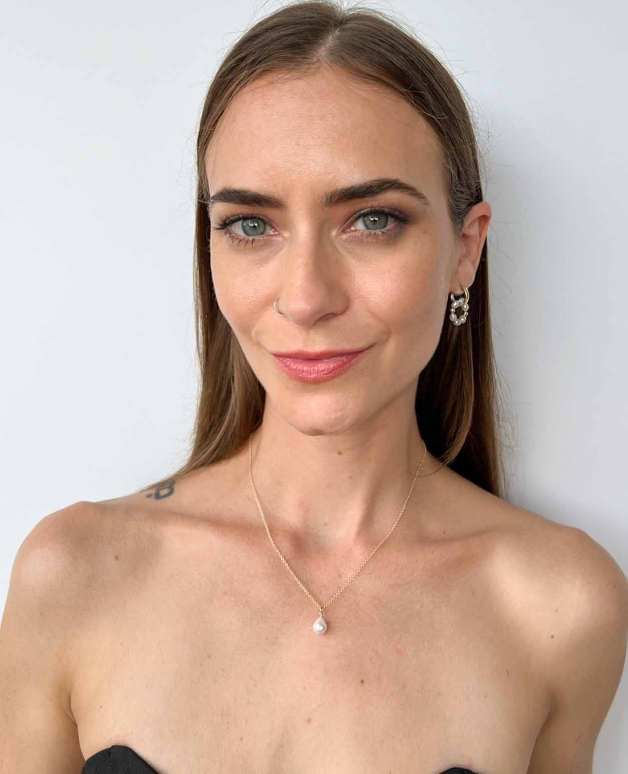 model wearing huggie earrings and necklace from the Vivara Collection of baroque pearls