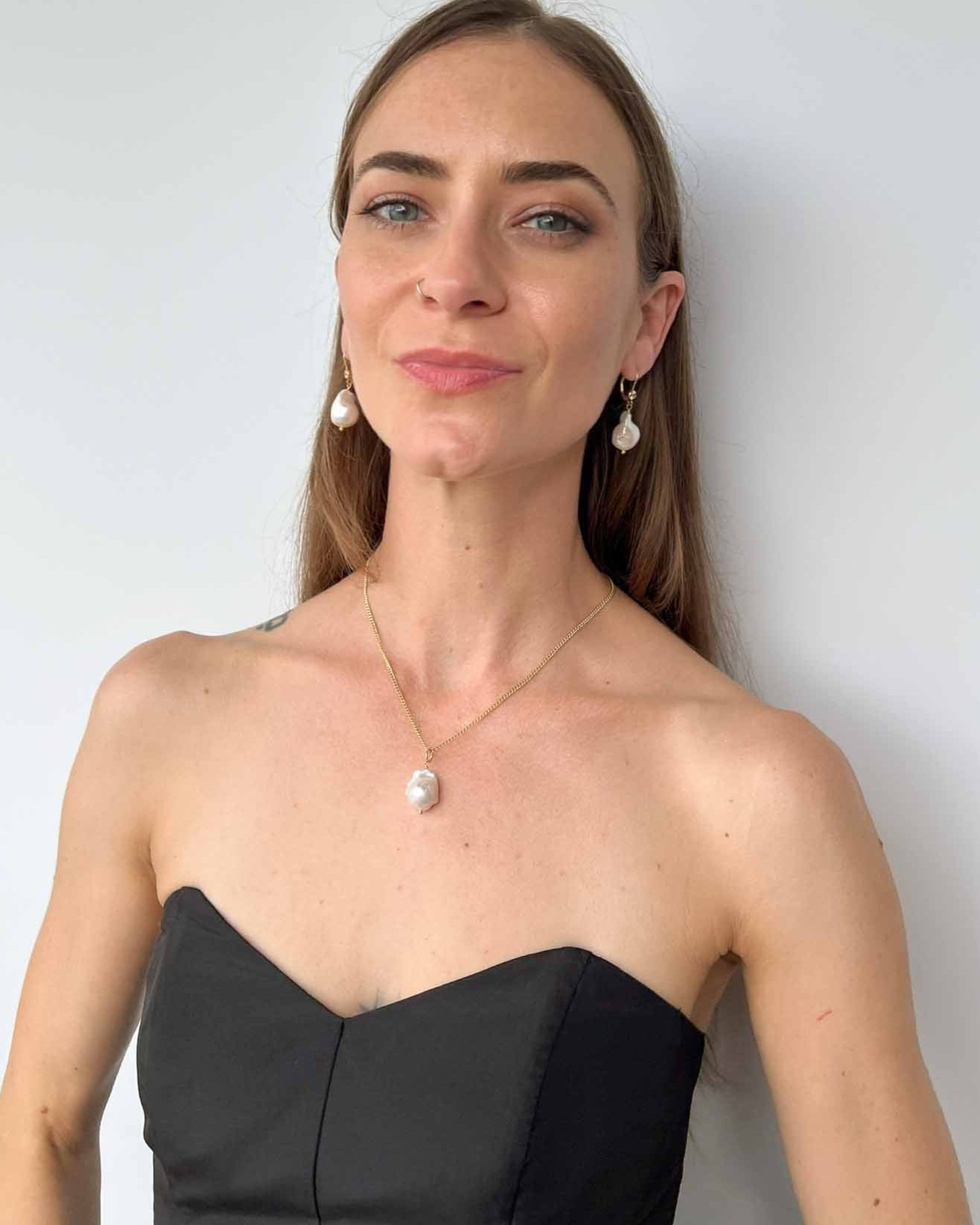 model wearing baroque pearl necklace and earrings