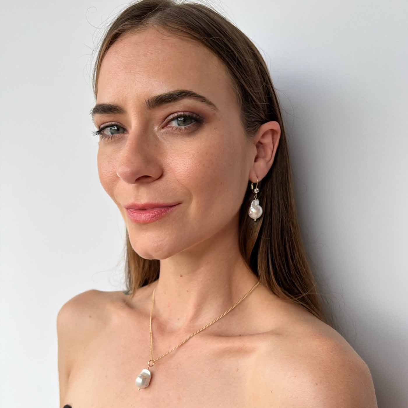 model wearing Raja Baroque pearl earrings and necklace