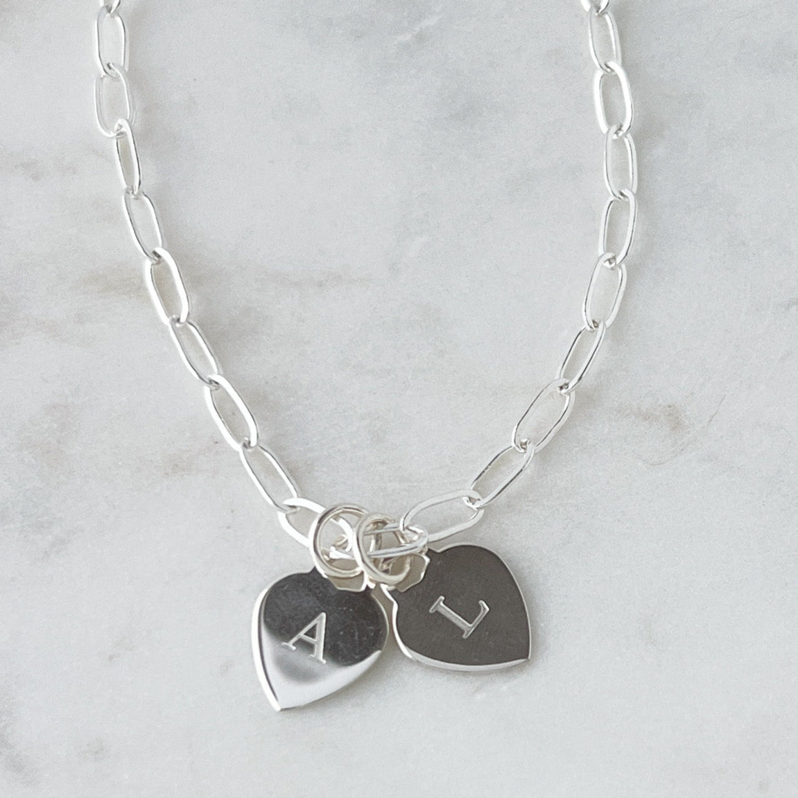 sterling silver heart charms engraved with a single letter