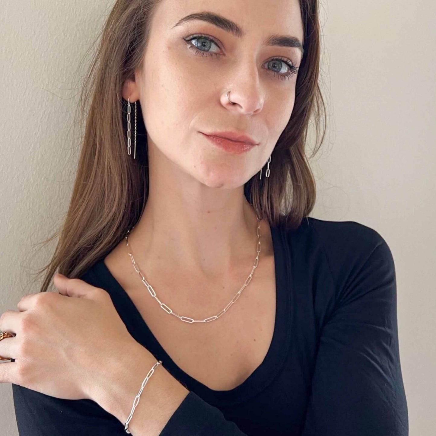 sterling silver paper clip chain necklace on model. set includes bracelet and threader earrings
