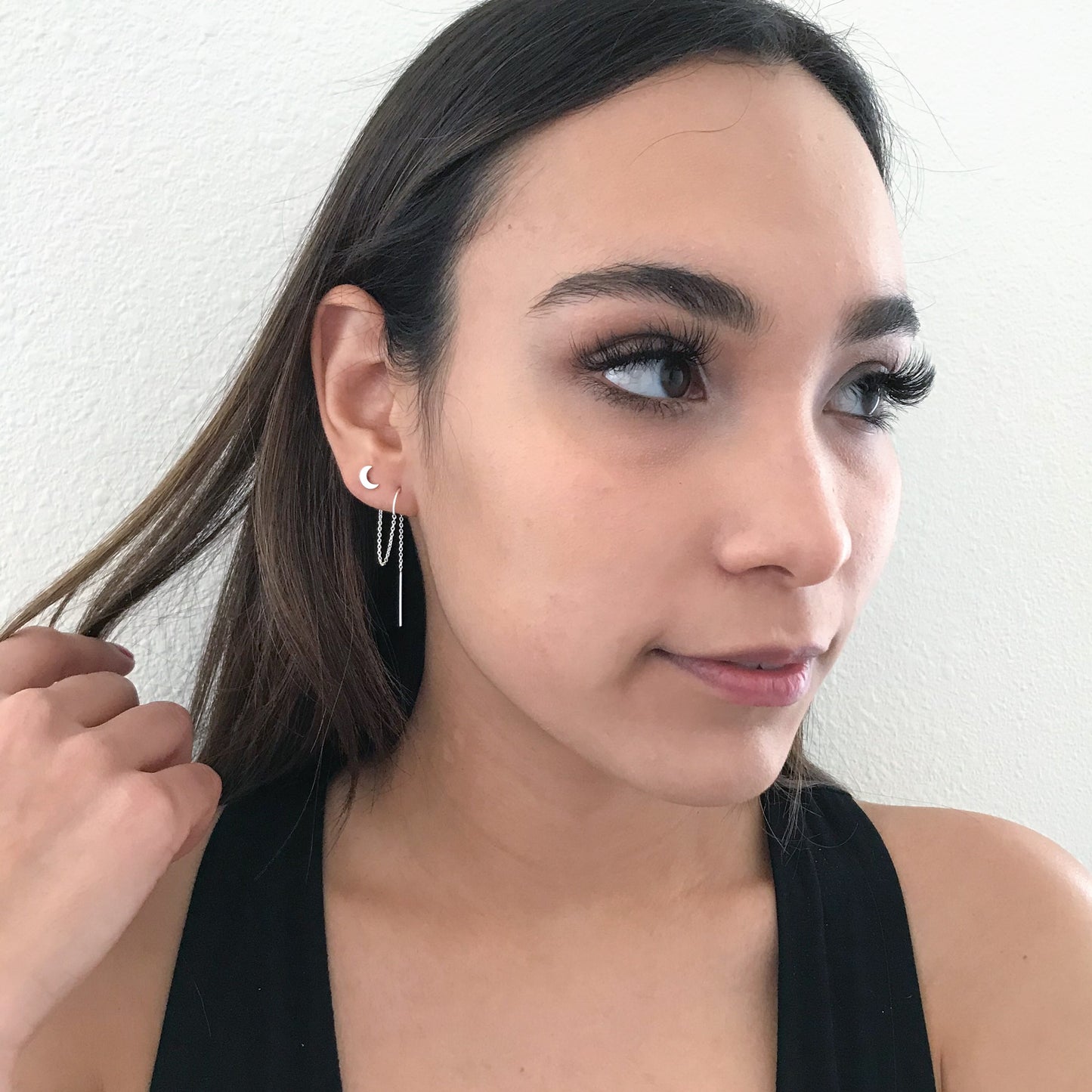 model wearing star and moon earrings