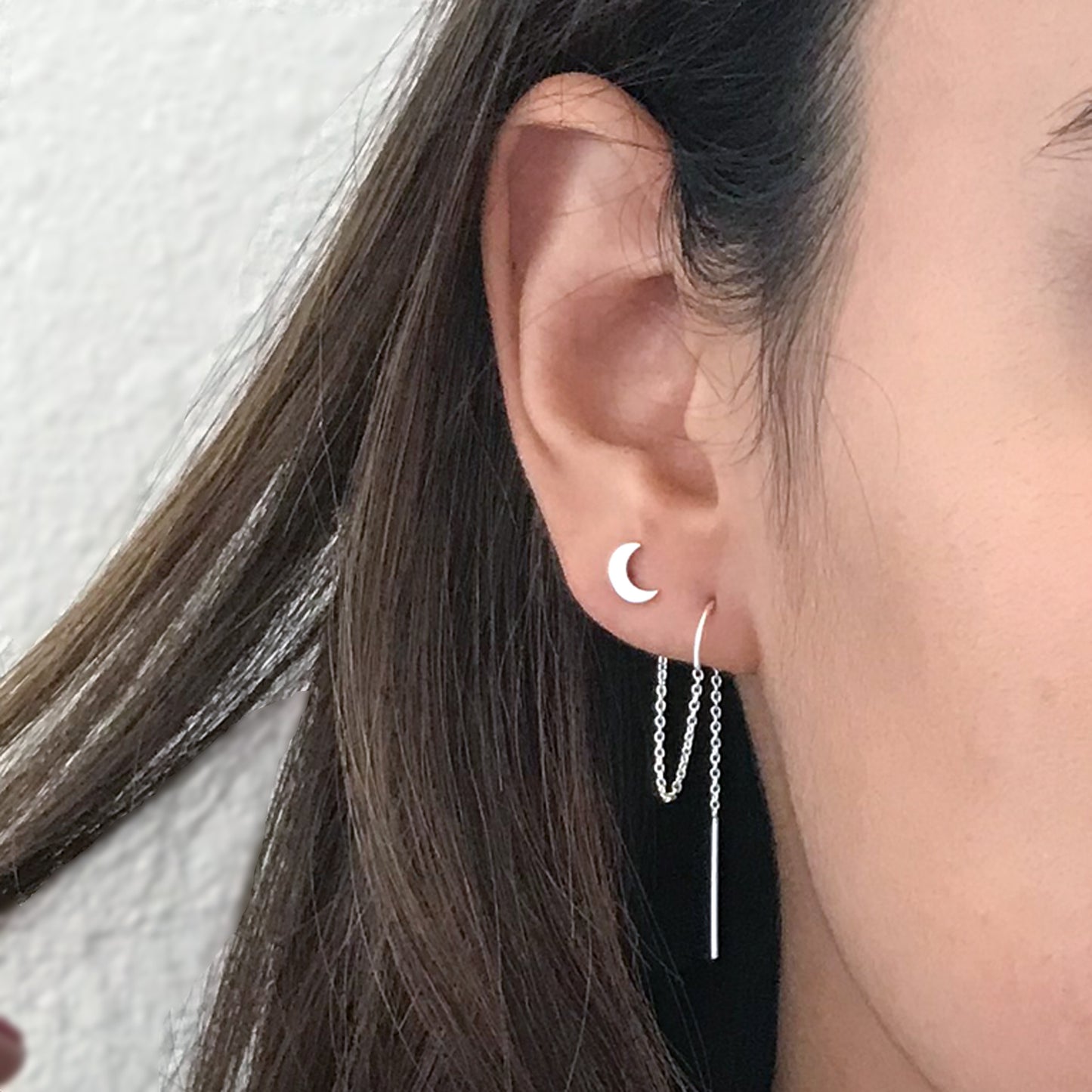 close up of model wearing sterling silver moon for two hole earrings
