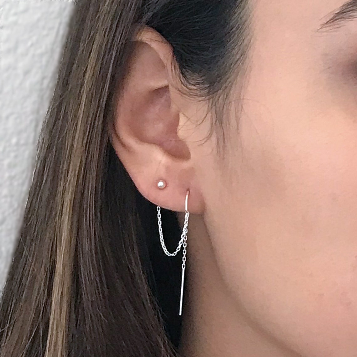 close up of model with double piercing earrings in sterling silver