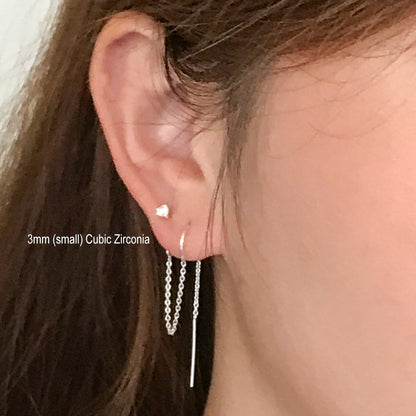 model ear close up of two earlobe piercings earrings in 3mm cz