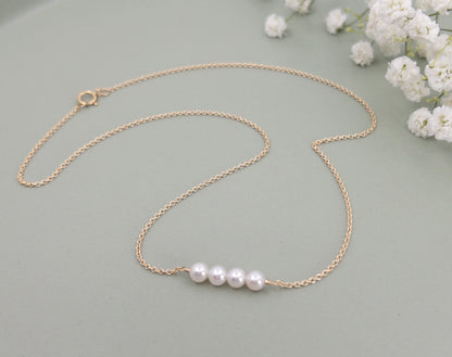 four pearls on gold chain