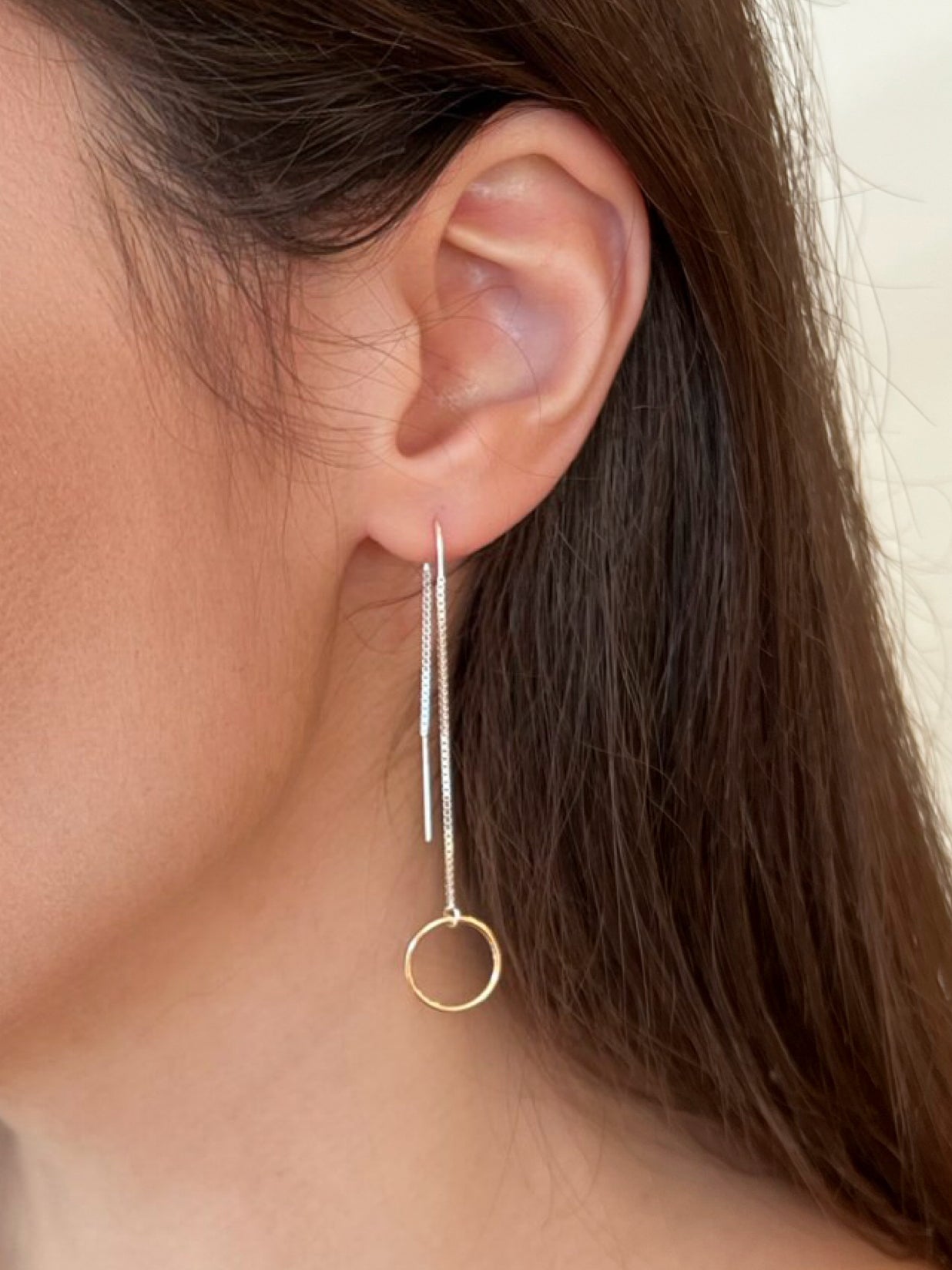 Mixed metal gold and silver long dangle earrings.  Model is wearing long silver threader earrings with 14k gold filled ring in front