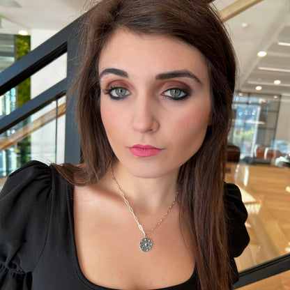 model wearing moon phases pendant on paperclip chain