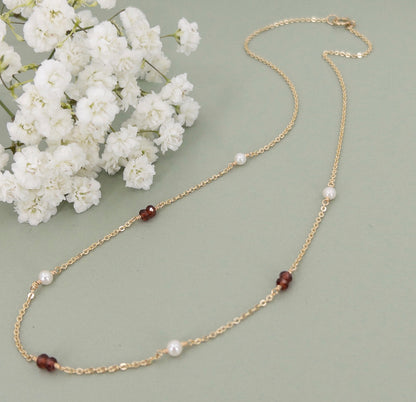 tiny garnets and freshwater pearls stationed on a gold chain