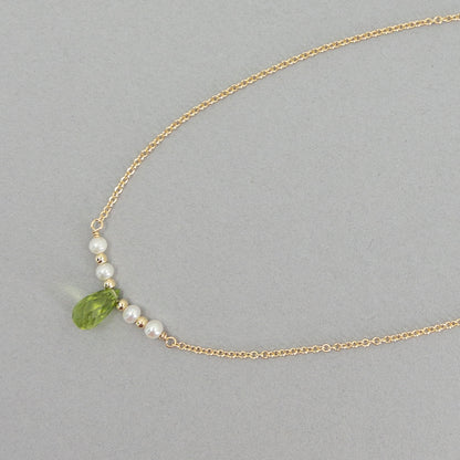 close up of peridot and pearl dainty necklace