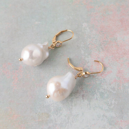 close up of large pearl earrings on leverback ear wires