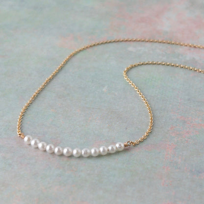 Dainty pearl necklace from the Gigi Collection featuring 12 tiny pearls