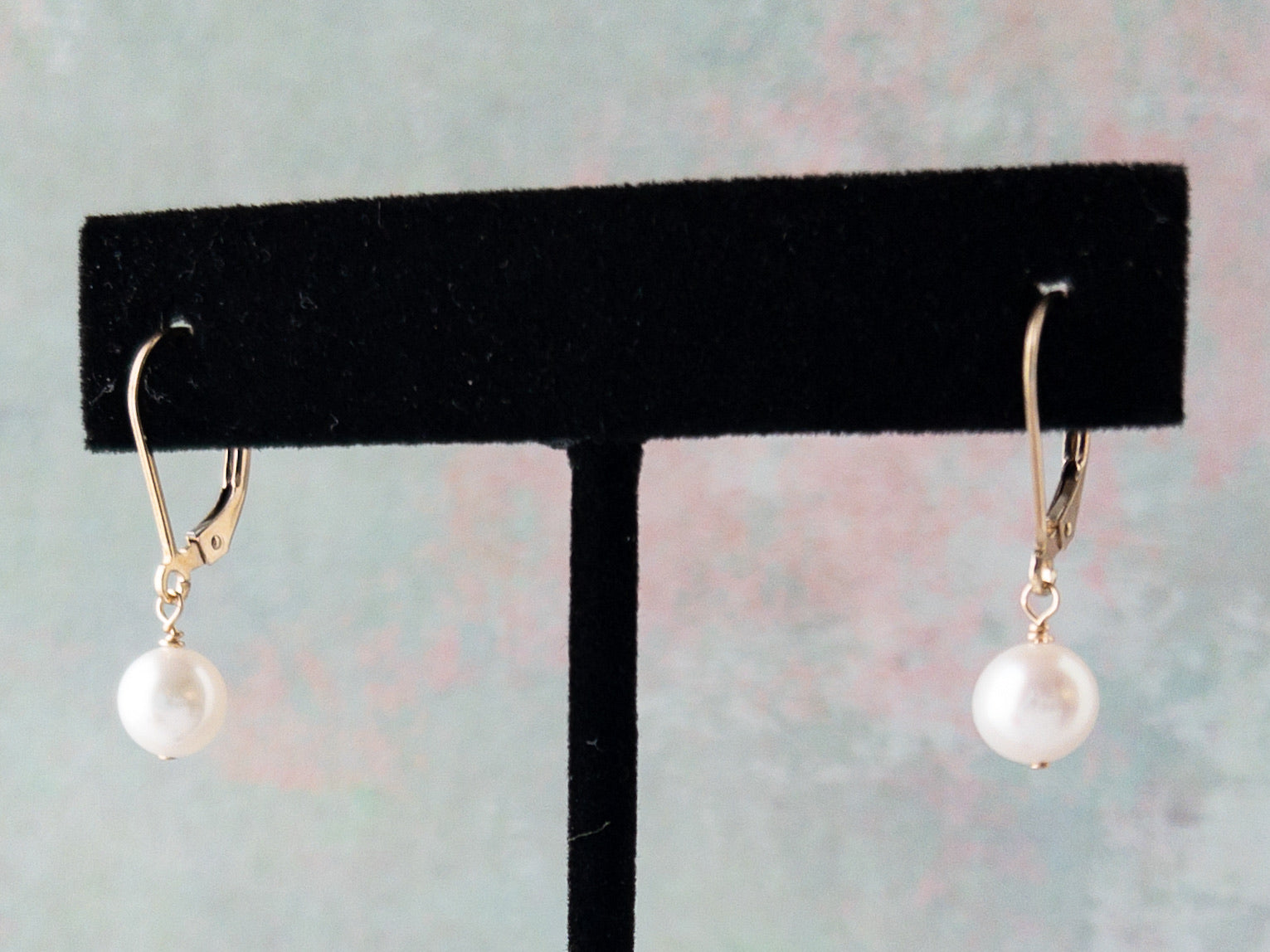 Lucia pearl earrings on earring stand