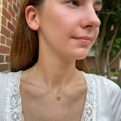 model wearing dainty peridot necklace on 14k gold filled chain.  Also, available in sterling silver