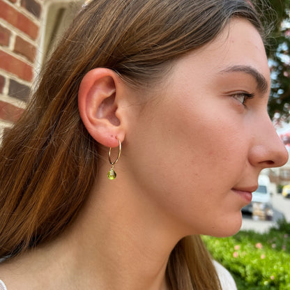 model wearing peridot earrings