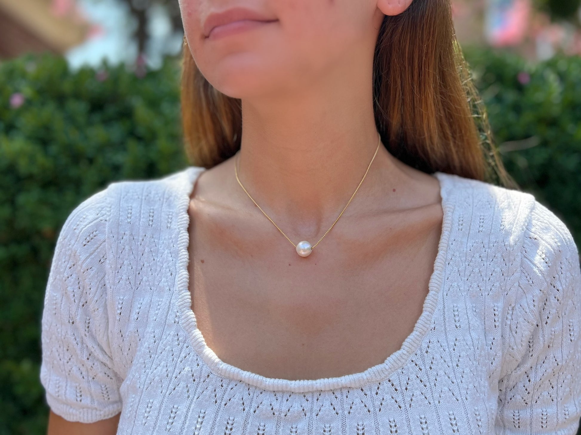 Model wearing 1 pearl necklace in 14k gold filled