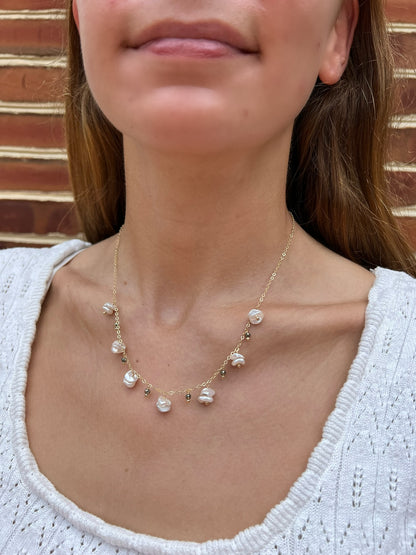 close up of model wearing organically shaped keshi pearls with tiny pyrite gemstones