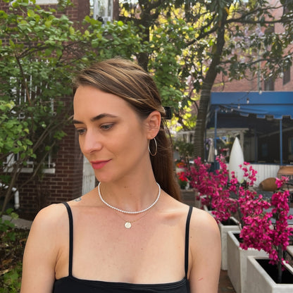 model wearing white freshwater pearl strand necklace in 16 inch length