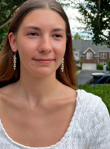 model wearing long dangle  freshwater pearl earrings 