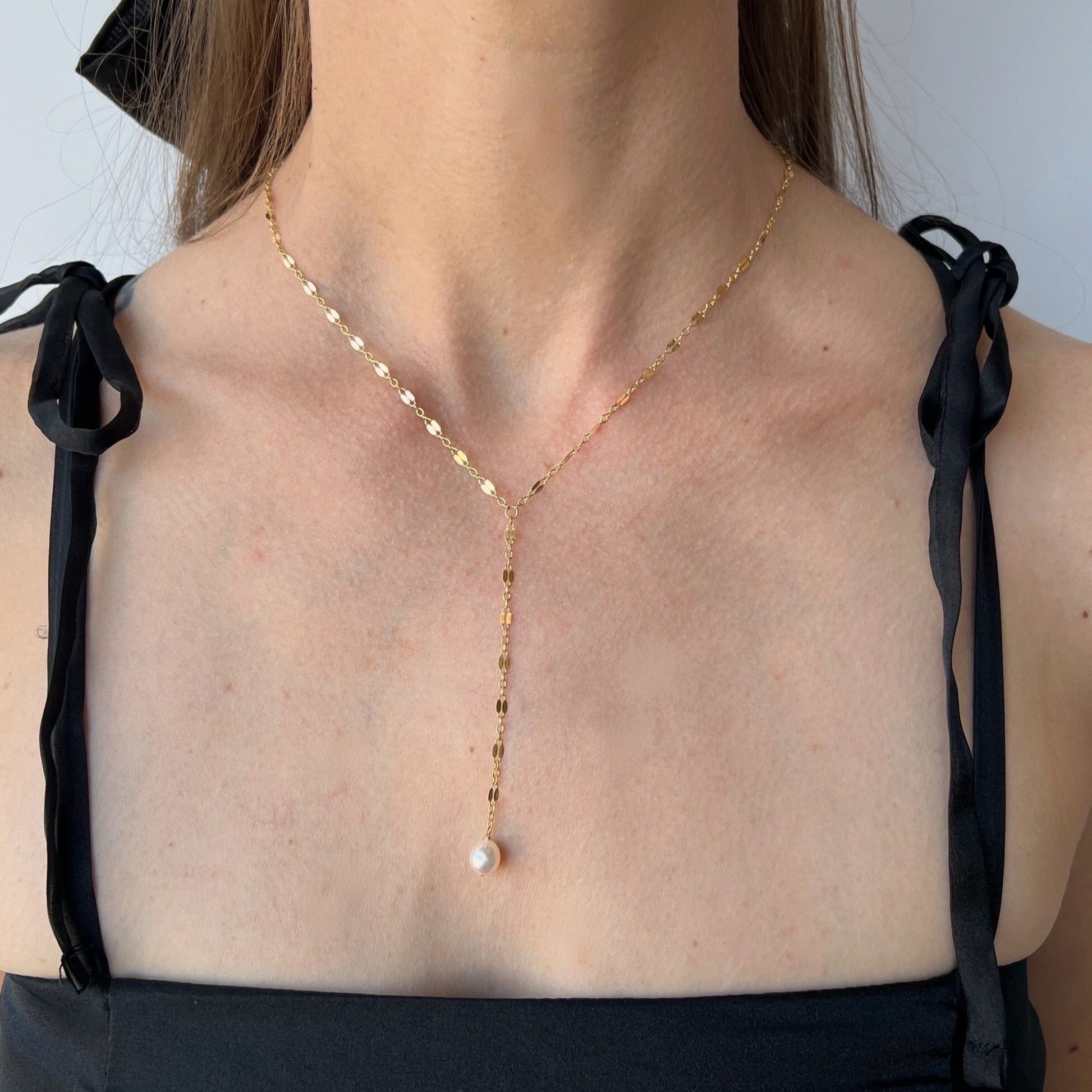model wearing Isabella lace chain pearl Y necklace in gold