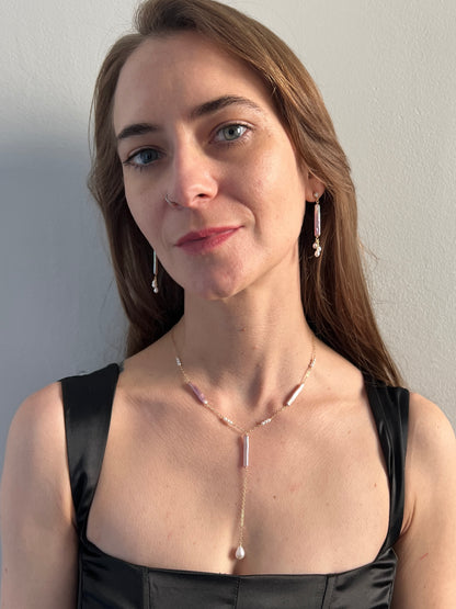 model wearing pearl lariat necklace with matching earrings