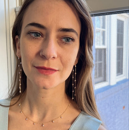 model wearing blush pearl necklace with matching earrings