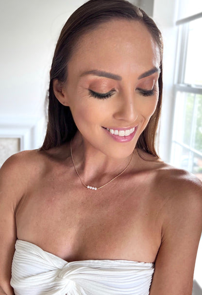 model wearing the 4 pearl version of the Lucia Add A Pearl Necklace