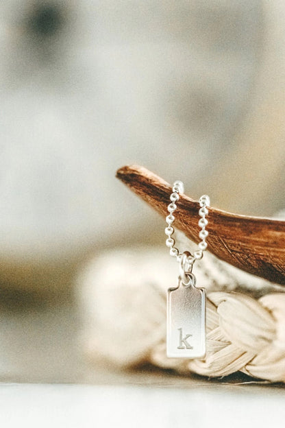 close up of engraved tag with letter K