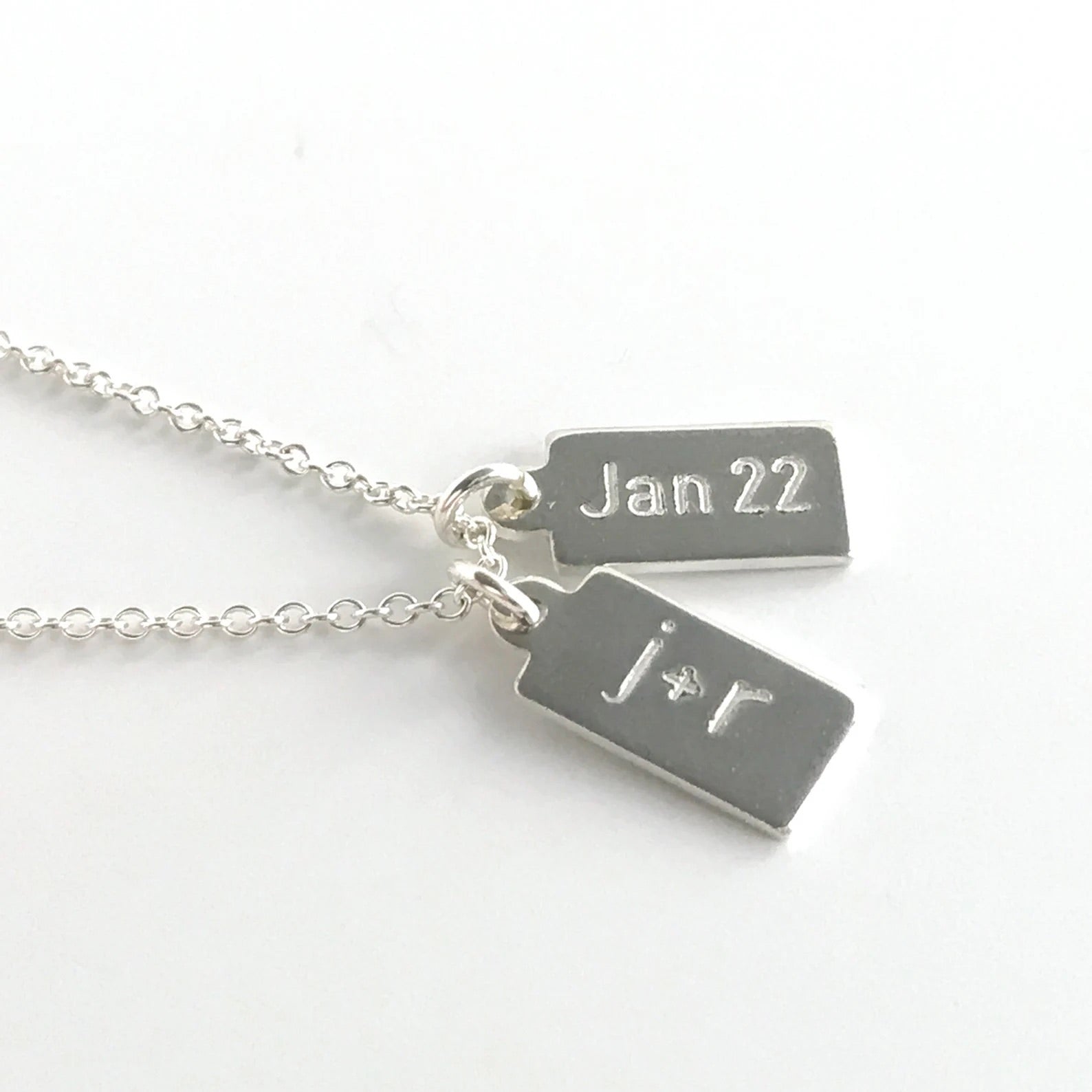 sterling silver dog tag necklace showing two tags with engraving